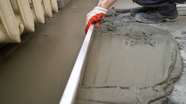 istock Laying paving slabs. Pointing a patio with dry grouting cement grouting mix. Seeded fine sand on paving slabs - grouting. Sand with the help of the rule is rubbed into the seams of paving slabs. Grouting paving slabs. 2227609156