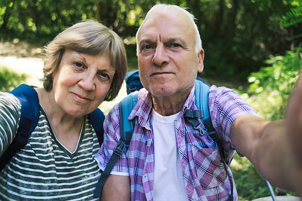 istock Elderly Couple Smiling at Camera During Hiking Trip 2227610241
