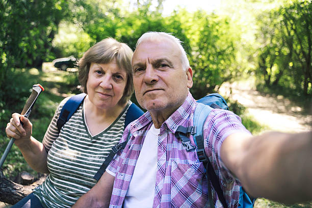istock Elderly Couple Posing for Selfie in the Forest 2227610251