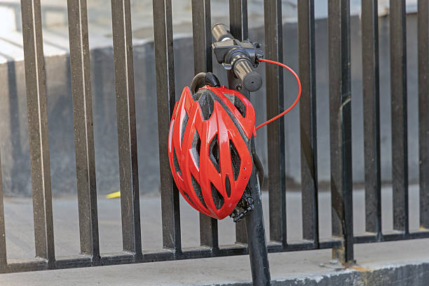 Bright Red Helmet With Ventilation for Summer Hanging at Electric Scooter Handle Bar