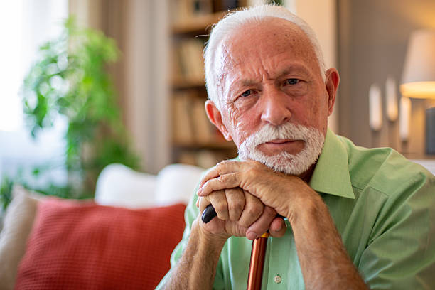 istock Senior man leaning on walking cane at home expressing sadness 2227611573