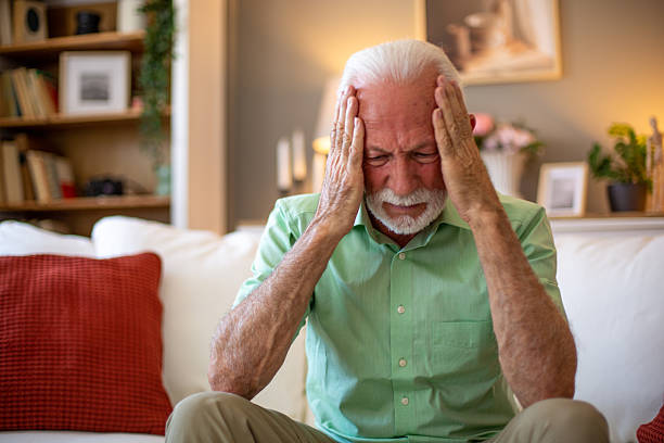 istock Senior man suffering from a strong headache at home 2227611623