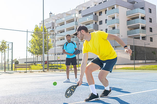 istock Two young men playing pickleball on a sunny day 2227611628