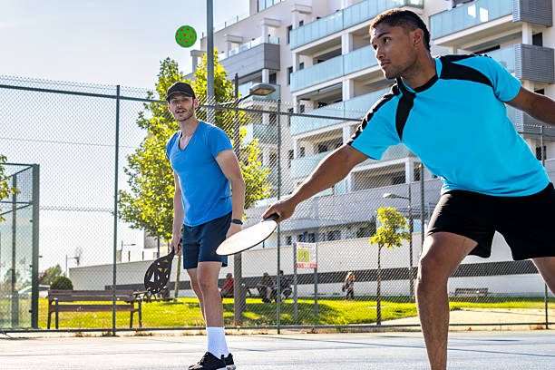 istock Two young men playing pickleball on a sunny day 2227611658