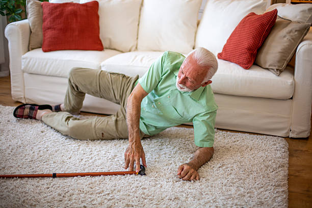 istock Elderly man fallen on the floor reaching for his cane 2227611696