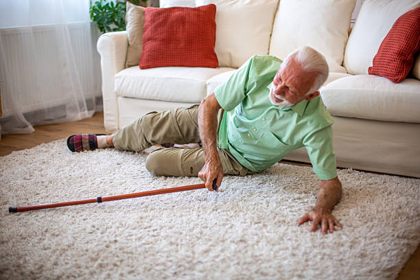 istock Senior man falling down on the carpet at home, reaching for his cane 2227611722