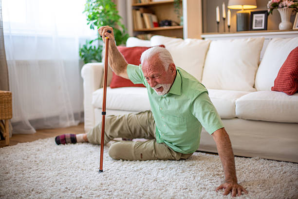 istock Senior man falling down on the floor at home, holding a walking cane 2227611793