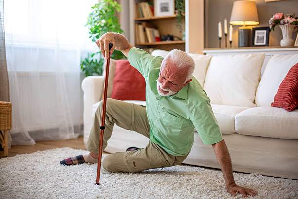 istock Senior man falling down with walking stick in living room 2227611798