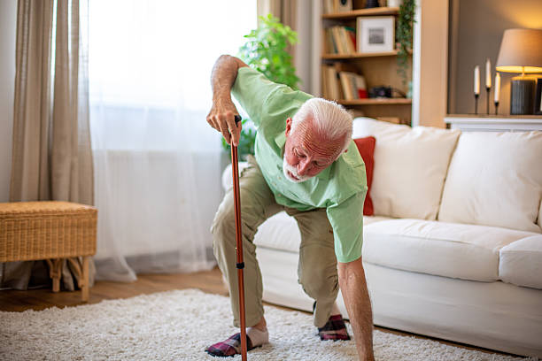 istock Senior man getting up from floor after falling at home using walking cane 2227611829