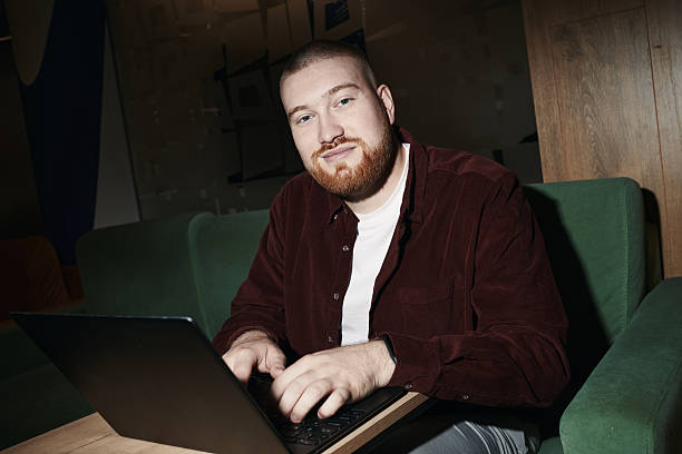istock Portrait of Confident Young Caucasian Man Smiling While Using Laptop 2227612666