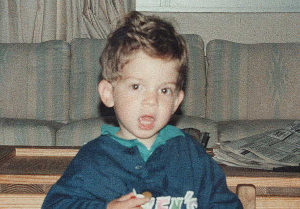 istock photo taken in 1980s: Smiling little boy looking at the camera 2227613541