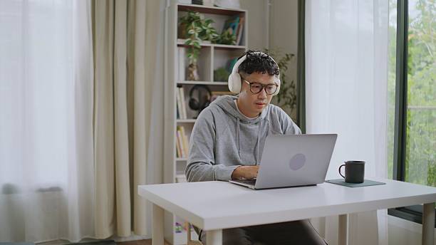 istock Asian Social Media Admin Replying to Customers While Working at Desk. 2227614873