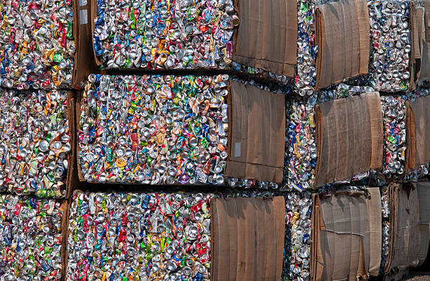 A full frame close-up photograph of bales of crushed aluminum cans for recycling.
