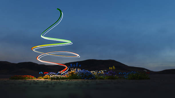 Colorful light spiral illuminating flowers in the desert, CGI