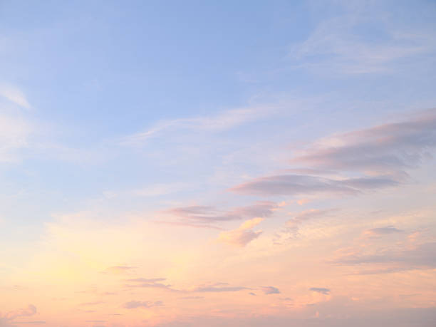 Captured in Denmark, this serene sky showcases soft pastel gradients at sunset with delicate cloud patterns spanning the horizon. Perfect for conveying tranquility, nature's beauty, and the subtleties of Scandinavian evenings.