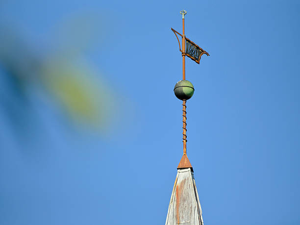 istock Weather vane and spire under a blue sky emphasizing minimalism and architecture 2227617255
