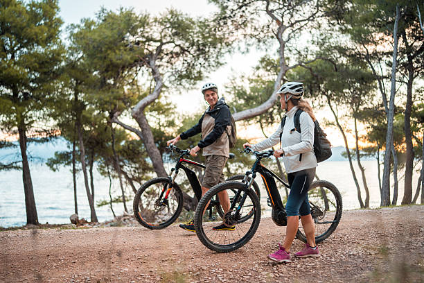 istock Active Senior Couple With Bicycles at Sunrise Seaside 2227617835