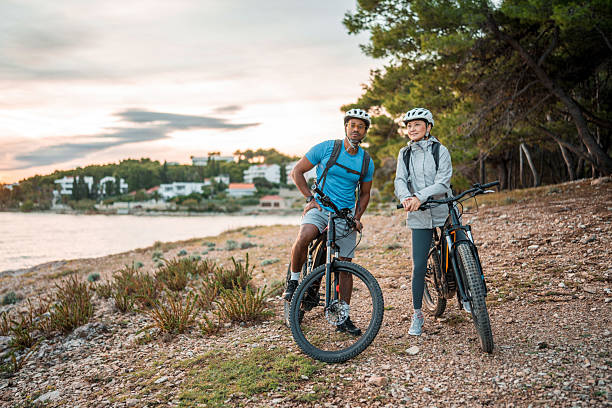istock Diverse Couple with Electric Bikes Enjoying Coastal Sunrise 2227617837