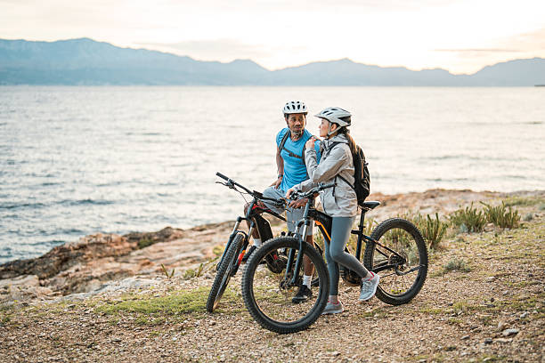 istock Seaside Sunrise Adventure with Diverse Couple and E-Bikes 2227617842