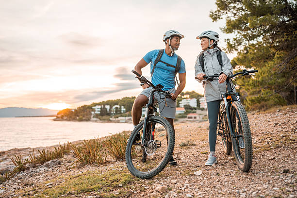 istock Diverse Couple with E-Bikes Relishing Seaside Sunrise 2227617844