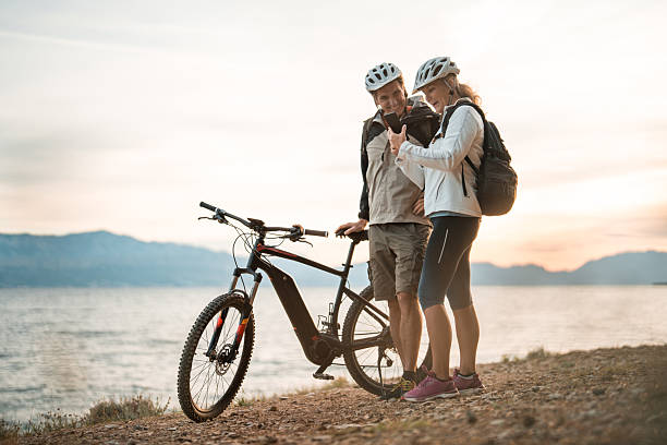 istock Active Seniors with E-Bikes Enjoying Sunrise Coastal Scene 2227617854