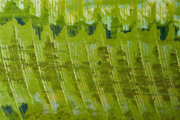 Vivid green surface showcases intricate, layered strokes that create a dynamic texture, reflecting light and adding depth to the artwork during daylight.