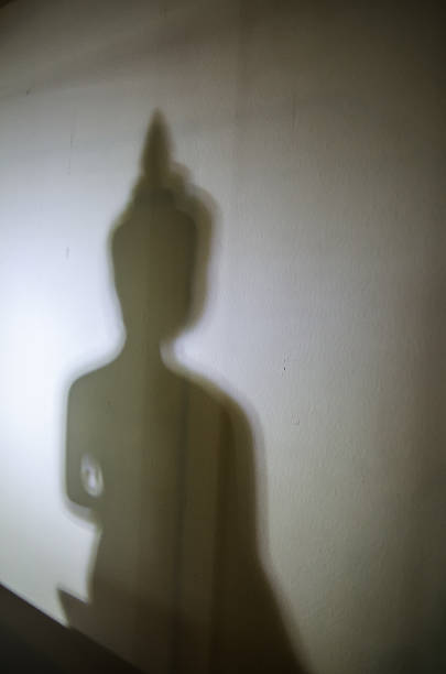 istock Blurred photo of Buddha statue shadow on a white wall. 2227619018