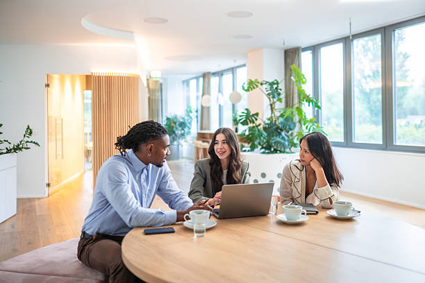 istock Diverse Team Engages in Business Strategy with Laptop in Office 2227621622