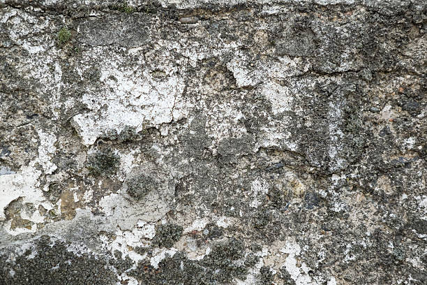istock Weathered and cracked concrete wall, displaying age and texture. backgrounds or urban themes 2227623759