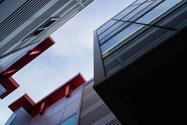 Low-angle view capturing the striking geometric interplay of modern building facades