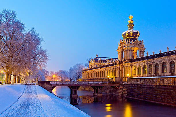 View of the illuminated old town of Dresden with the Dresden Frauenkirche and the Zwinger on the Elbe.