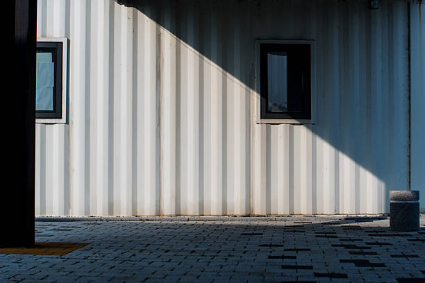 istock Modern Building Facade with Stark Geometric Shadows and Paving Stones 2227626313