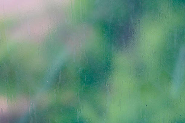 An abstract and blurry view through a wet or fogged window