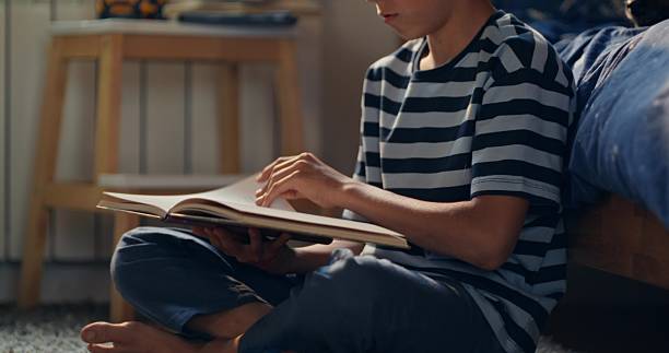 istock The boy reads at home 2227636334