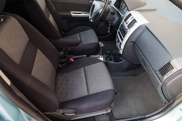 istock Comfortable front seats inside the car: the driver and passenger, tied with black fabric trim, modern interior design, the steering wheel covered and a luxurious center console. 2227638511