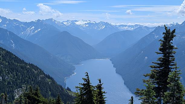 istock Beautiful calm lake surrounded by mountain range under majestic clouds 2227639523