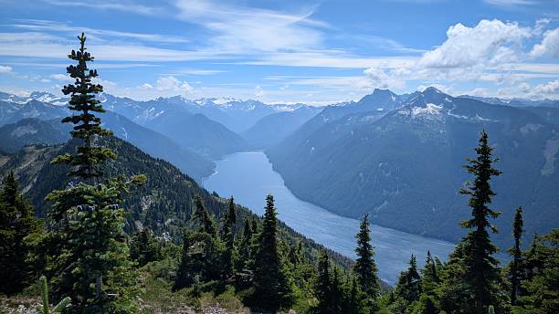 istock Beautiful calm lake surrounded by mountain range under majestic clouds 2227639602