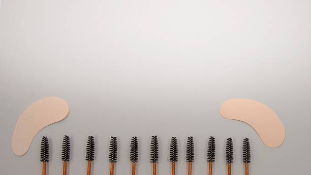 istock Eyelash Extension Brushes and Eye Patches on Neutral Background 2227639641