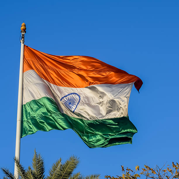 istock India flag flying high at Connaught Place with pride with plain white background, India flag fluttering, Indian Flag on Independence Day and Republic Day of India, tilt up shot, Har Ghar Tiranga 2227639993