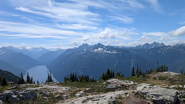 istock Beautiful calm lake surrounded by mountain range under majestic clouds 2227640688