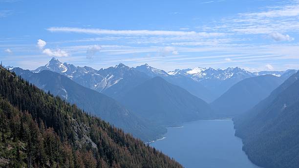 istock Beautiful calm lake surrounded by mountain range under majestic clouds 2227640712