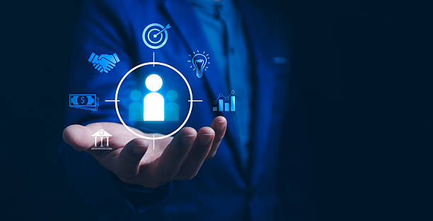 istock Customer Centricity and Business Strategy. A businessman presenting a customer icon at the center, surrounded by elements of targeting, innovation, financial goals, collaboration, and market analysis. 2227640866