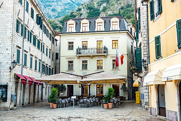 Kotor Old Town in Kotor Municipality, Montenegro, with shop signs visible.