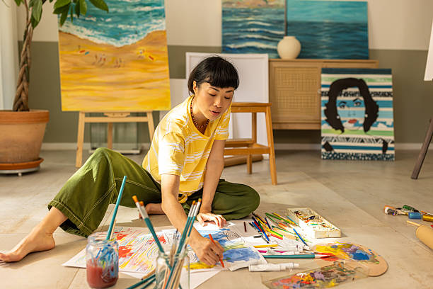 istock Woman painting at home in bright studio space 2227642961