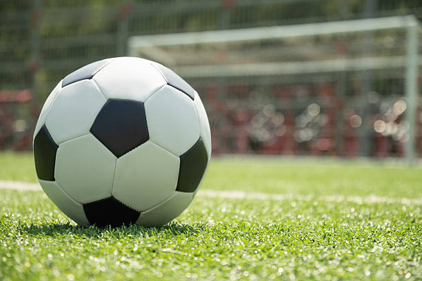 istock Soccer Ball on Field in Front of Goal Post 2227644539