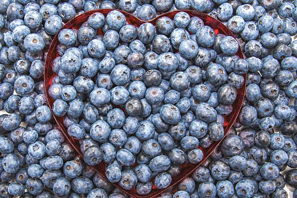 Blueberries in heart shaped form with small white hearts
