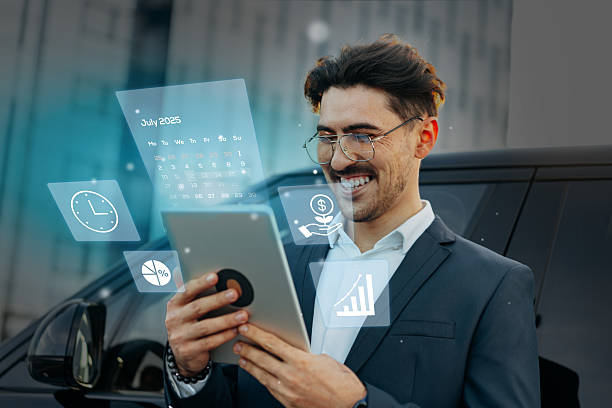 istock Business professional uses tablet in front of modern vehicle while analyzing data and planning for future success 2227649643