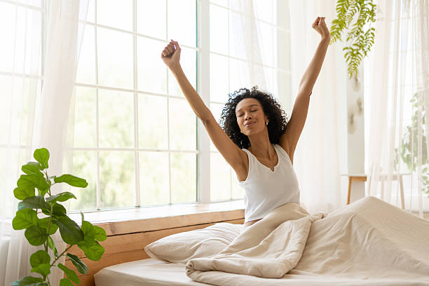 istock Young Woman Stretching in Bed After Waking Up 2227651385