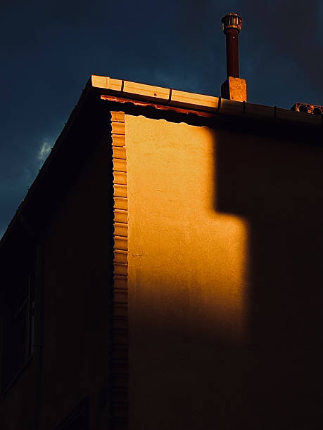 Abstract View of a Building Corner and Chimney Lit by Warm Sunset Light