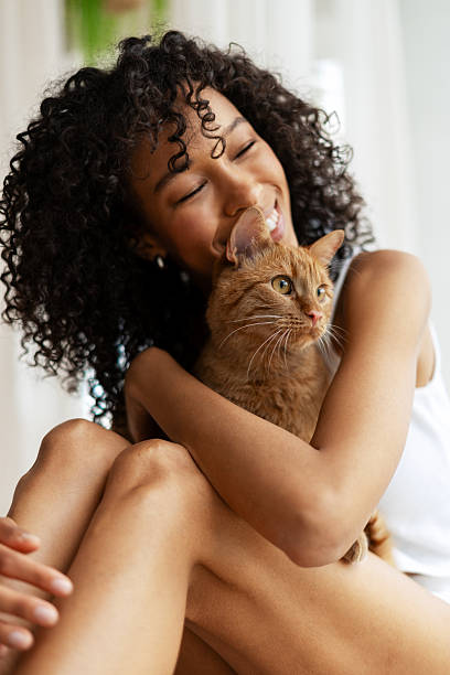 istock Young woman cuddling her ginger cat at home 2227651810